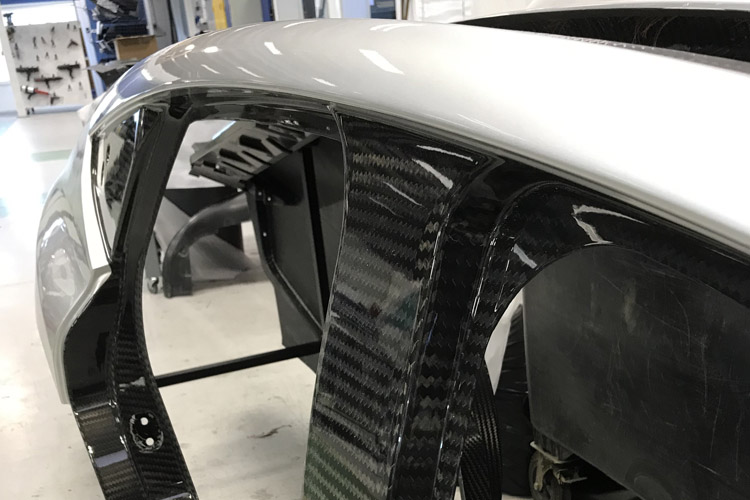 Reclaimed carbon fibre (rCF) Structural Bodyside with virgin reinforcements. Photo courtesy of Prodrive Composites.